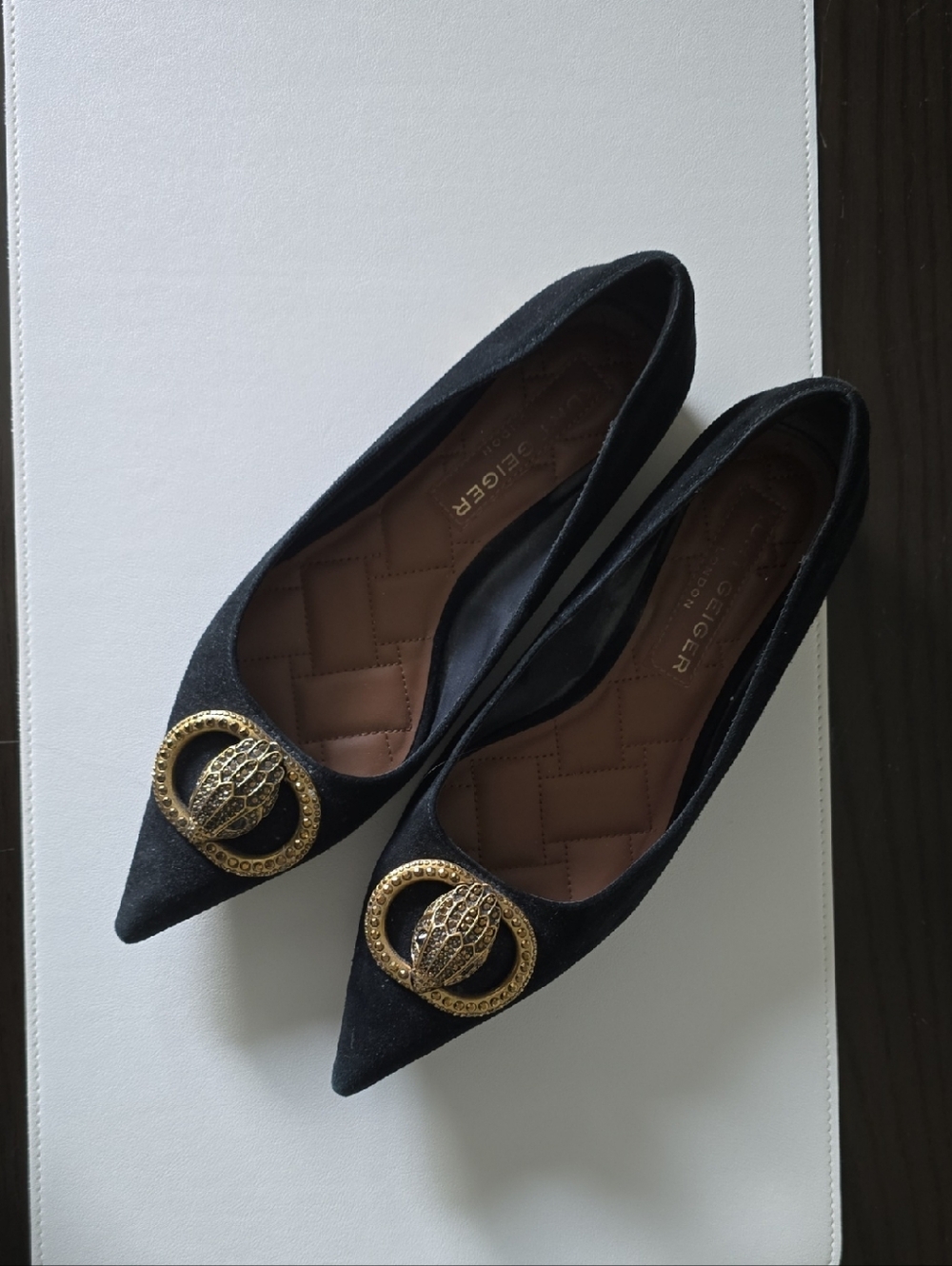 Kurt Geiger Black Pointed Toe Flats with Gold Medallion